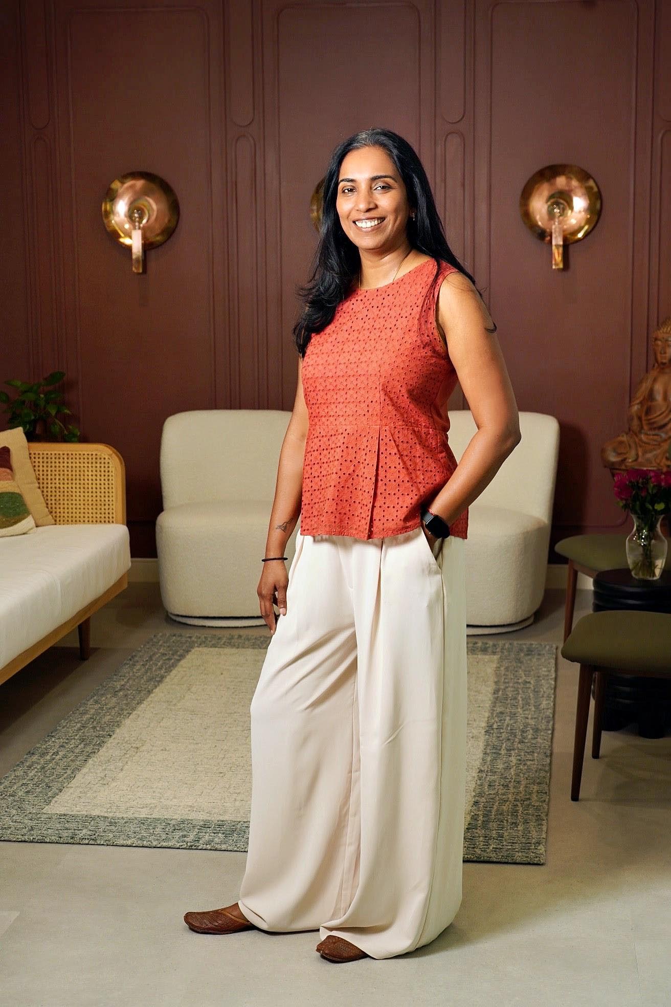 Dr. Archana Srinivasan, dentist and founder of Ateeth Dental Care in Reston, VA, smiling in a modern dental office, showcasing her professional and welcoming demeanor.